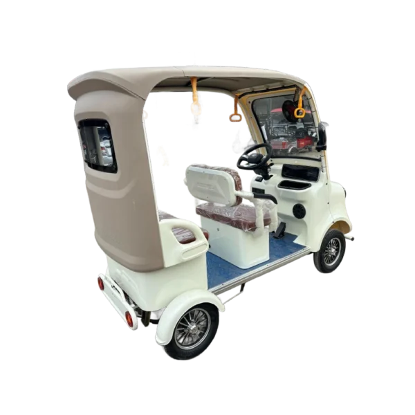 Rear angled view of beige electric tricycle with covered cabin and passenger seating