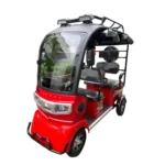 Red electric passenger tricycle with enclosed cabin and passenger seating