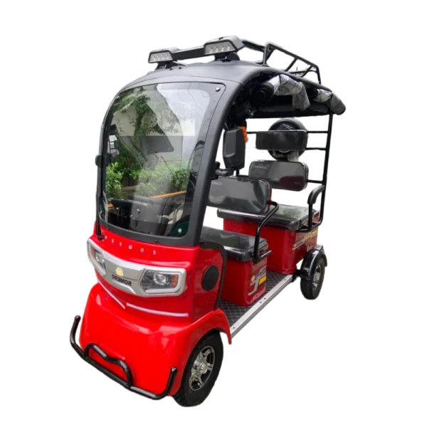 Red electric passenger tricycle with enclosed cabin and passenger seating