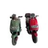 Front view of electric motorcycles in green and red showing design and lighting