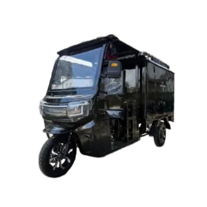 Angled front view of electric passenger tricycle with enclosed body and roof