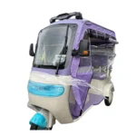 Side view of covered electric passenger tricycle with weather protection enclosure