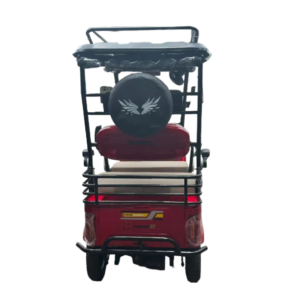 Rear view of red electric tricycle with spare wheel and passenger seating setup